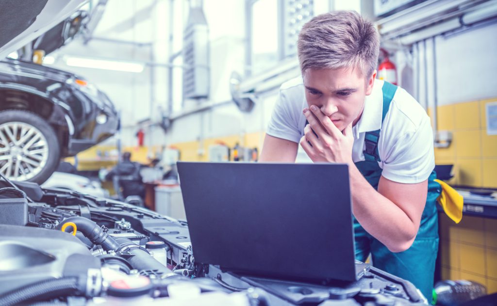 Mechanic stuyding a computer screen - Car Diagnostics Ely