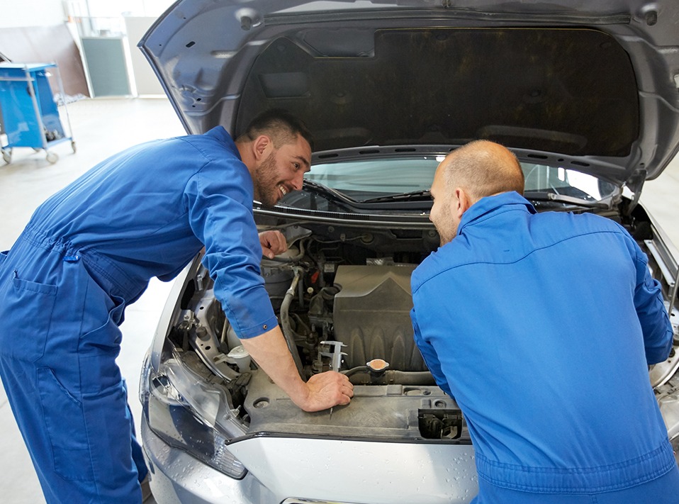 Mechanic looking under a vehicles bonnet - Car Servicing Ely